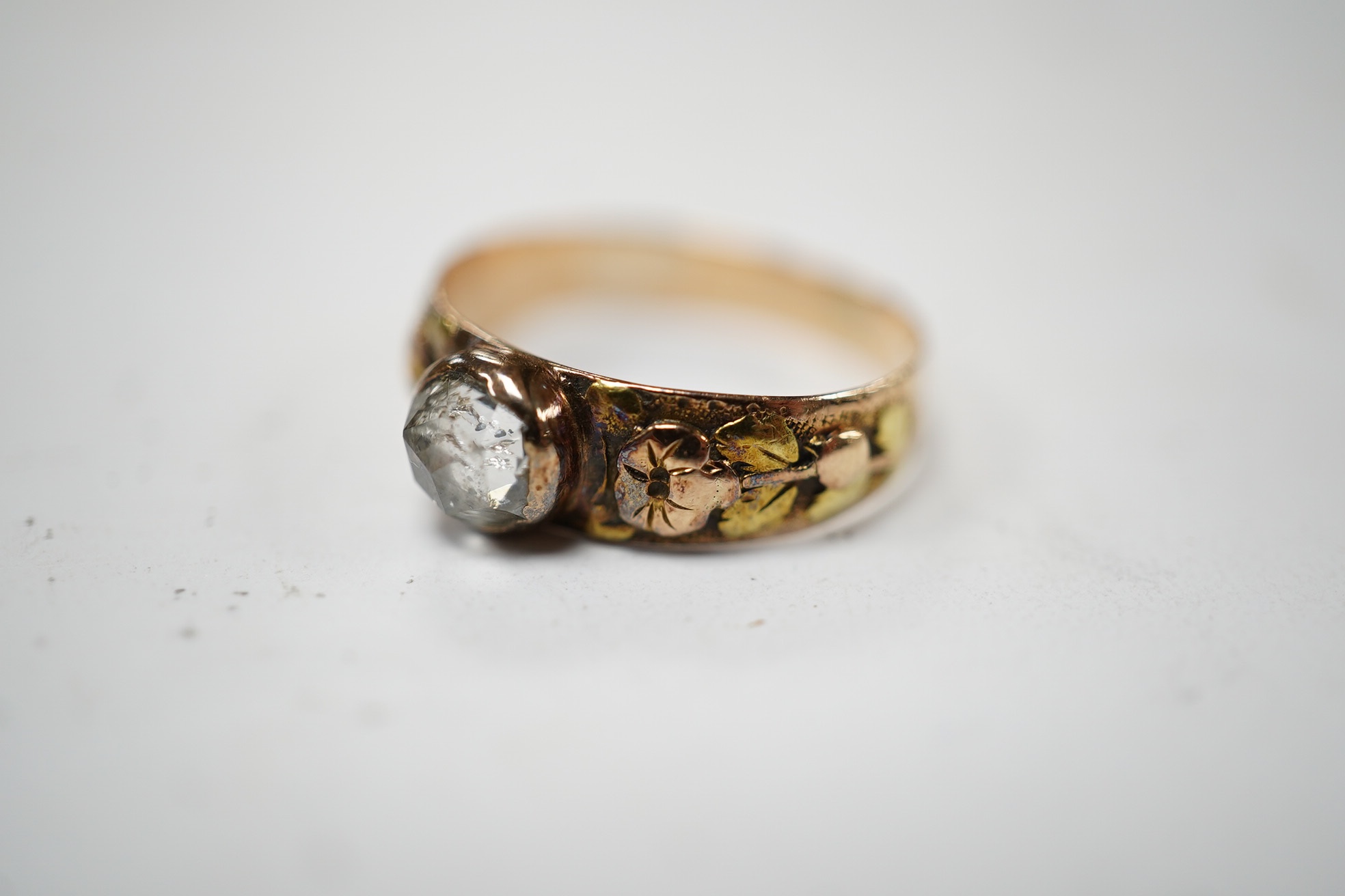 An antique two colour yellow metal and single stone rose cut diamond set ring, size I, gross weight 1.9 grams. Condition - fair